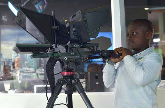 A boy learns how to use a studio camera at KidZania London. A boy learns how to use a studio camera at KidZania London.