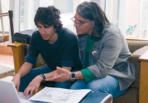 Iranian filmmaker Ali Shah Hatami reviews the storyboard with his son. Iranian filmmaker Ali Shah Hatami reviews the storyboard with his son.
