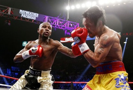 Floyd Mayweather Jr. exchange punches with Manny Pacquiao during their welterweight unification championship bout, May 2, 2015. (Getty Images) Floyd Mayweather Jr. exchange punches with Manny Pacquiao during their welterweight unification championship bout, May 2, 2015. (Getty Images)