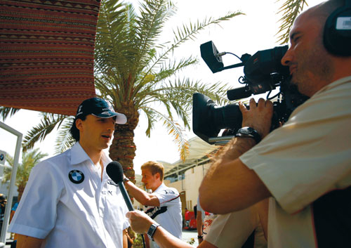 Polish driver Robert Kubica talks with a TV crew. An estimated 750 broadcasting staff covered the Bahrain Grand Prix which attracted a global TV audie Polish driver Robert Kubica talks with a TV crew. An estimated 750 broadcasting staff covered the Bahrain Grand Prix which attracted a global TV audie