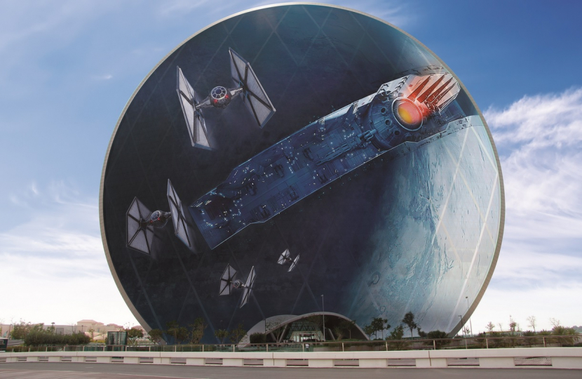 To celebrate the Middle East premiere of Star Wars: The Force Awakens in Abu Dhabi on Wednesday 16 December, twofour54 and Aldar Properties PJSC partnered to create a giant Star Wars-themed installation.
The 100-metre high installation is currently being placed on the iconic, coin-shaped Aldar HQ building and will feature the Starkiller Base from the latest episode of the blockbuster franchise. Those keen to find out the story behind the giant image will have to wait until the film opens in cinemas this weekend, as no details will be revealed in advance.
With assistance from twofour54 and the Abu Dhabi Film Commission, filming for Star Wars: The Force Awakens took place in Abu Dhabi during May 2014 with over 650 crew working across two locations. In Star Wars: The Force Awakens Abu Dhabi plays Jakku, a frontier desert planet in a remote section of the Outer Rim Territories.
Star Wars: The Force Awakens is the seventh instalment in the franchise and is anticipated to be one of the most successful films of all time. So far, it has smashed all records for advance ticket sales in the United States.
Star Wars: The Force Awakens is scheduled for general release in UAE cinemas on 17 December 2015.
BIG PICTURE: Star Wars grabs attention in UAE