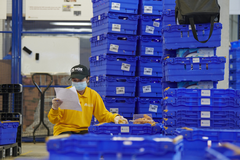 Leslie Cabig, customer service officer at VOX Cinemas checks orders at Carrefour fulfilment centre. Leslie Cabig, customer service officer at VOX Cinemas checks orders at Carrefour fulfilment centre.